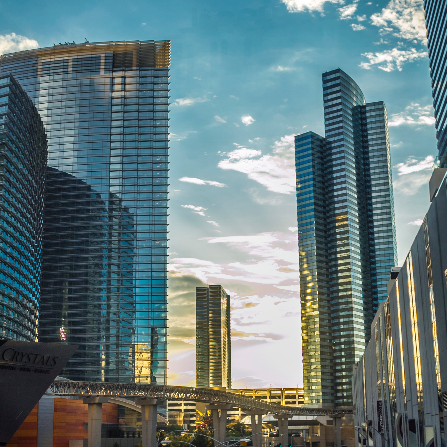 Glass skyscrapers with elevated metro at sunset